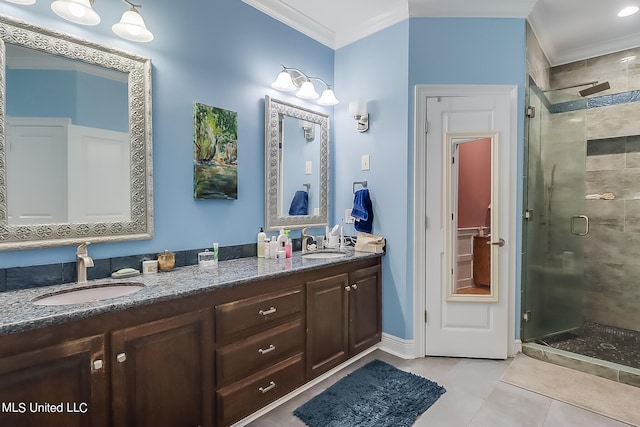 bathroom featuring vanity, crown molding, a shower with shower door, and tile patterned flooring