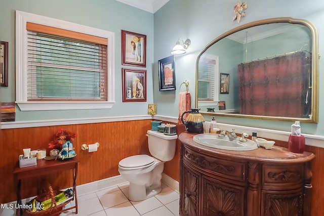 bathroom with vanity, ornamental molding, toilet, and tile patterned floors