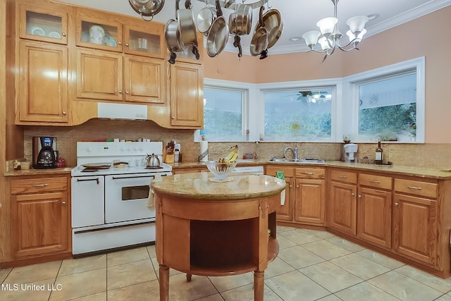 kitchen featuring a sink, tasteful backsplash, a notable chandelier, and range with two ovens