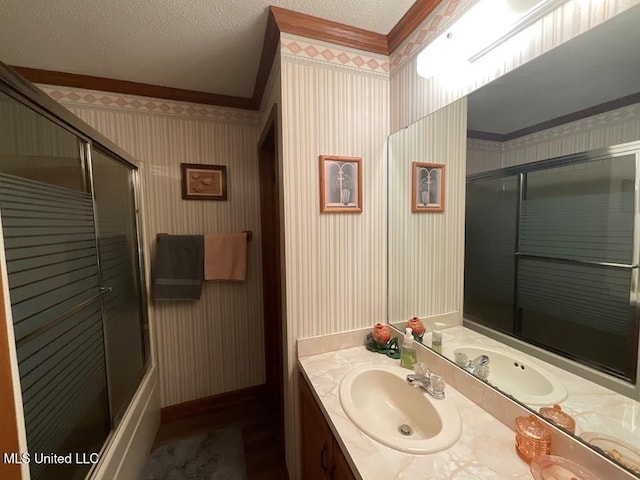 bathroom featuring vanity, ornamental molding, a textured ceiling, and walk in shower