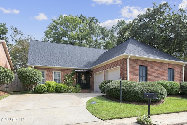 view of front of property with a garage and a front yard