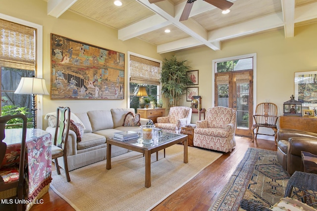 living room with coffered ceiling, hardwood / wood-style floors, and beamed ceiling