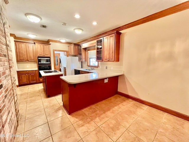 kitchen featuring kitchen peninsula, a breakfast bar area, a kitchen island, stainless steel microwave, and white fridge