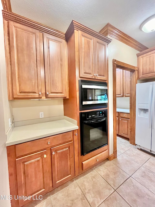 kitchen featuring oven, stainless steel microwave, a textured ceiling, and white fridge with ice dispenser