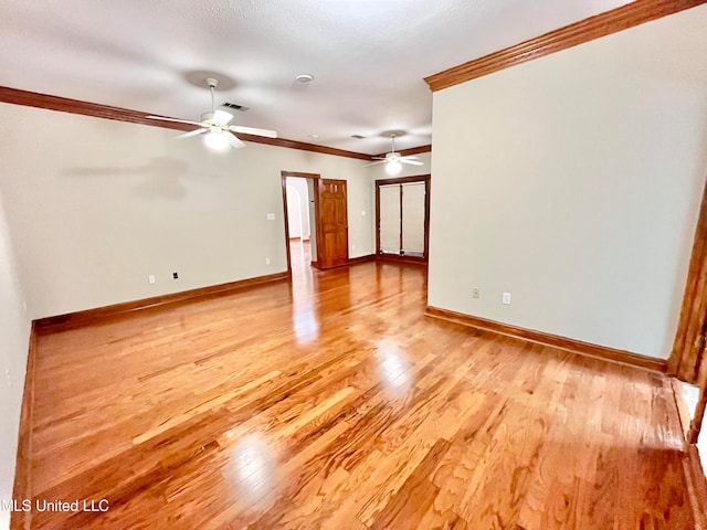 spare room with ceiling fan, ornamental molding, and light wood-type flooring