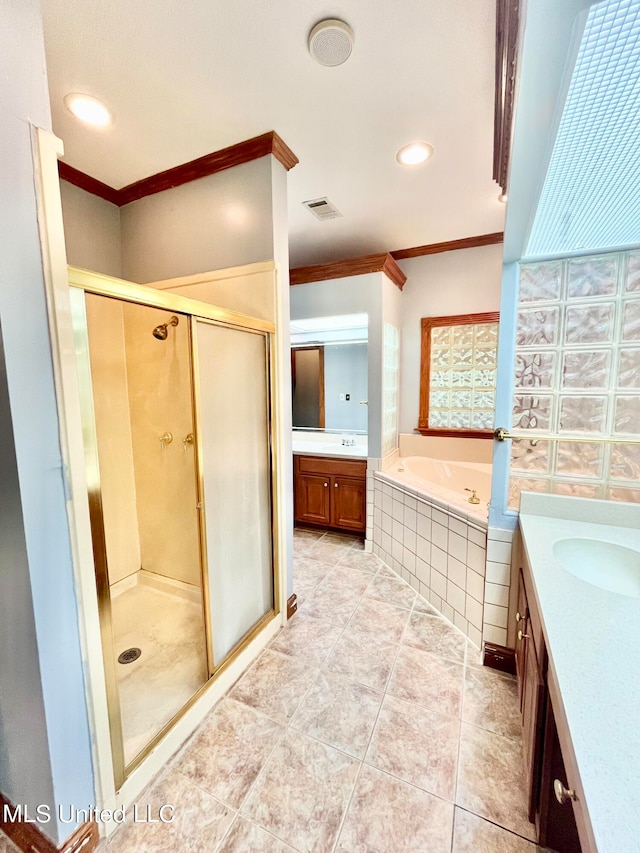 bathroom with vanity, ornamental molding, and separate shower and tub