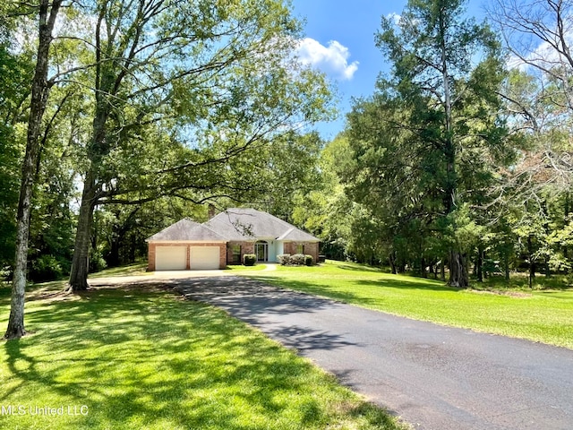 view of front of home with a front yard and a garage