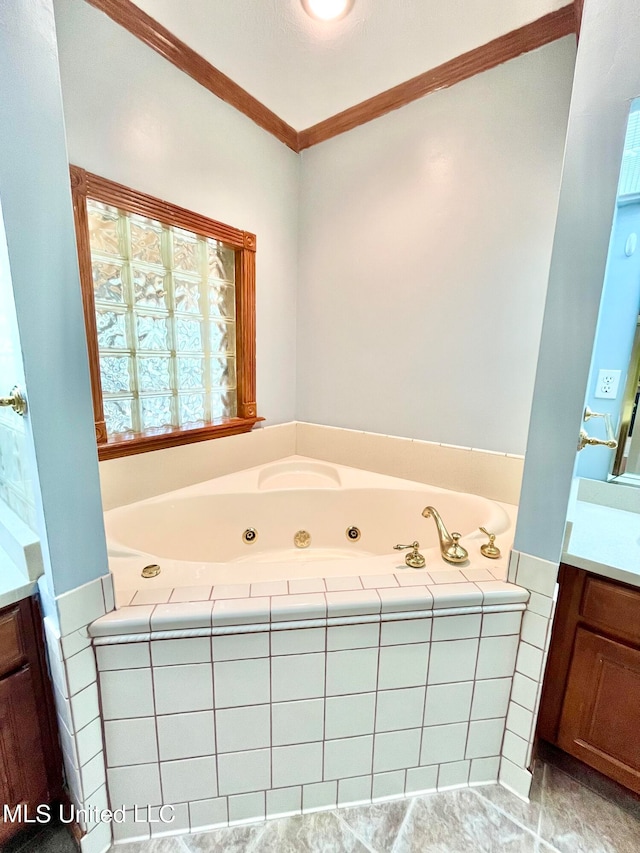 bathroom featuring vanity, a relaxing tiled tub, and ornamental molding