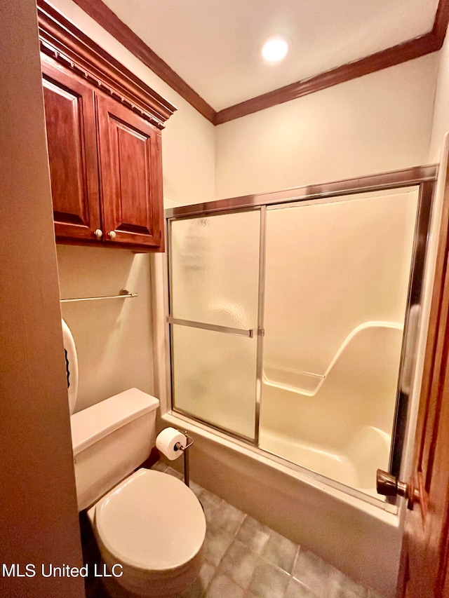 bathroom featuring toilet, ornamental molding, and bath / shower combo with glass door