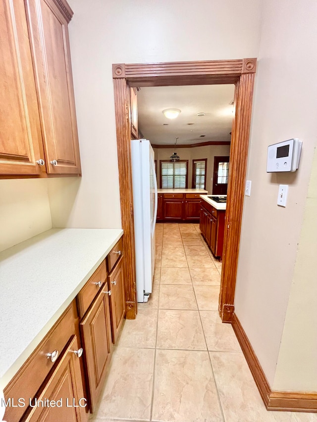 kitchen with light tile patterned flooring and white refrigerator