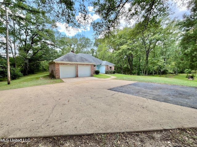 exterior space featuring a yard and a garage