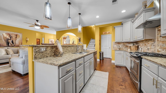 kitchen featuring sink, crown molding, decorative light fixtures, stainless steel range with gas stovetop, and dark hardwood / wood-style flooring