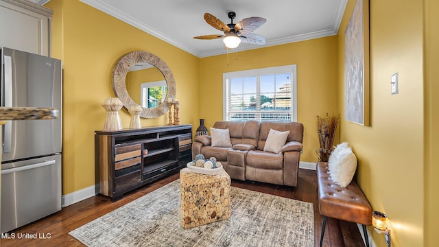 living room with dark wood-type flooring, crown molding, and ceiling fan