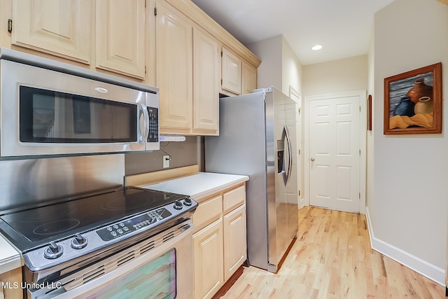 kitchen with light hardwood / wood-style floors and stainless steel appliances