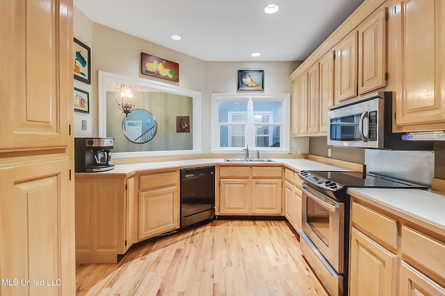 kitchen with light brown cabinets, stainless steel appliances, light hardwood / wood-style floors, and sink