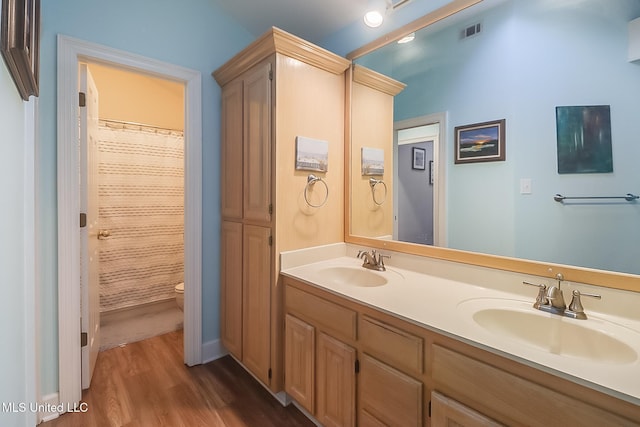 bathroom with hardwood / wood-style floors, vanity, toilet, and a shower with shower curtain