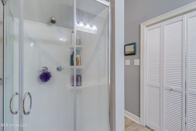 bathroom with hardwood / wood-style floors and walk in shower