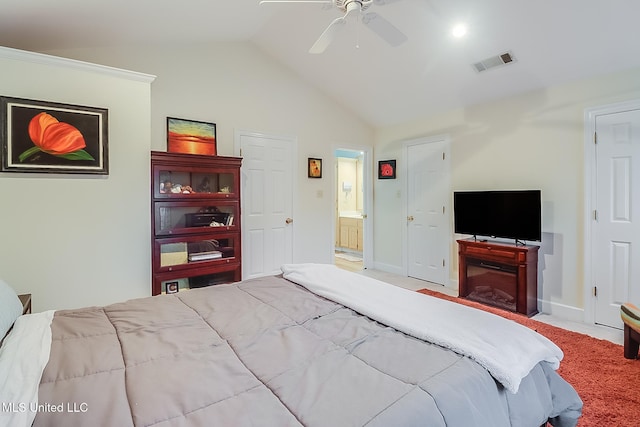 carpeted bedroom with ceiling fan, ensuite bathroom, and lofted ceiling