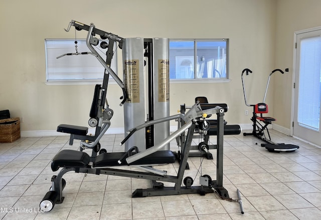 exercise area featuring light tile patterned floors