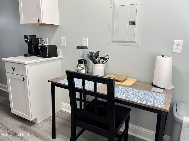 dining room with hardwood / wood-style flooring and electric panel