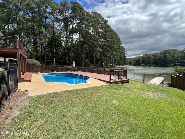 view of pool with a deck with water view and a yard