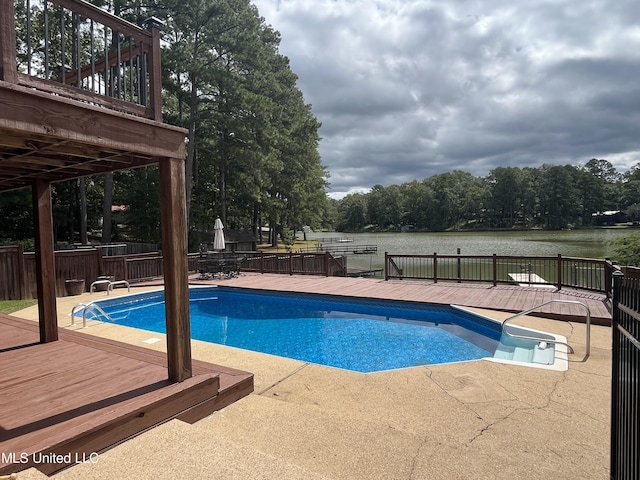 view of pool featuring a deck with water view and a patio