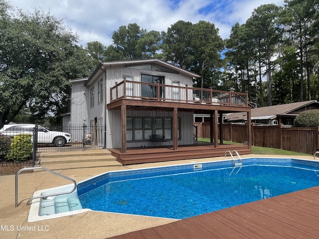 back of property with a swimming pool side deck