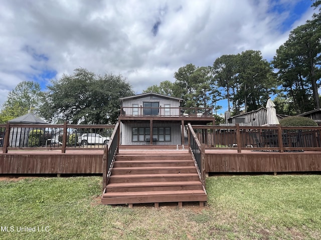 back of house with a deck and a lawn