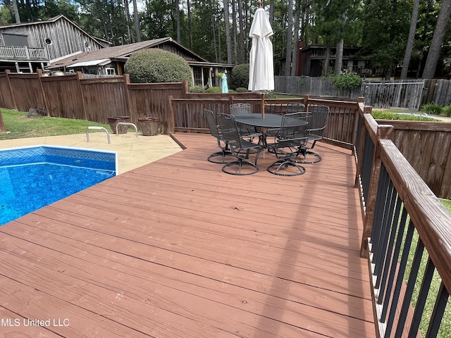 wooden deck featuring a fenced in pool