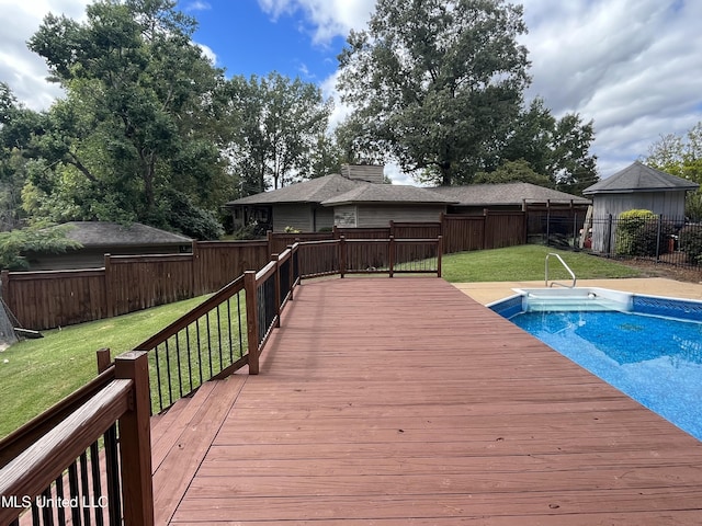 view of swimming pool featuring a yard and a wooden deck