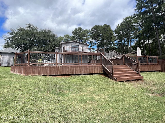 back of property featuring a yard and a deck