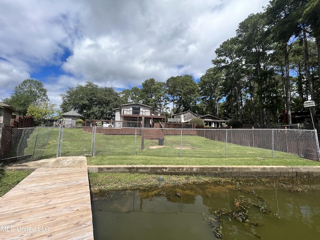 dock area featuring a water view and a lawn