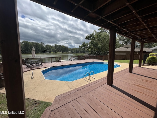 view of swimming pool featuring a patio area and a water view