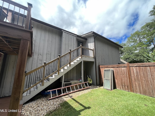 rear view of house featuring a lawn