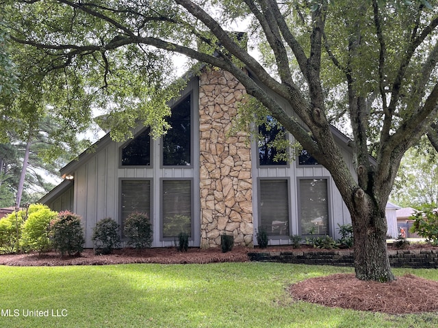 view of property exterior with a lawn