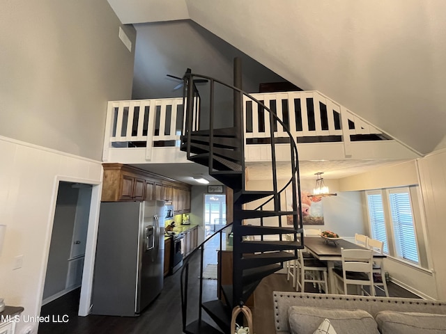 stairs with a chandelier, hardwood / wood-style floors, and a healthy amount of sunlight