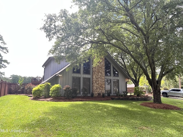 view of home's exterior with a lawn