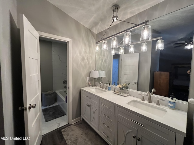 bathroom with vanity, ceiling fan, shower / bathtub combination, and hardwood / wood-style floors