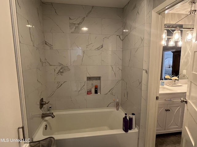 bathroom with vanity and tiled shower / bath combo