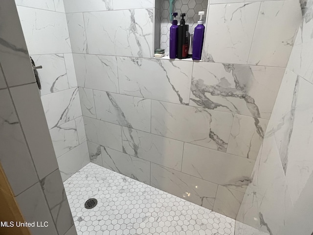 bathroom with tiled shower