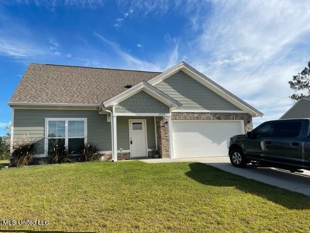 view of front of property with a garage and a front lawn