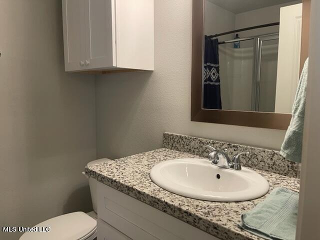 bathroom with vanity, toilet, and a shower with curtain