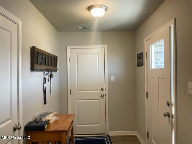 doorway to outside with dark hardwood / wood-style flooring