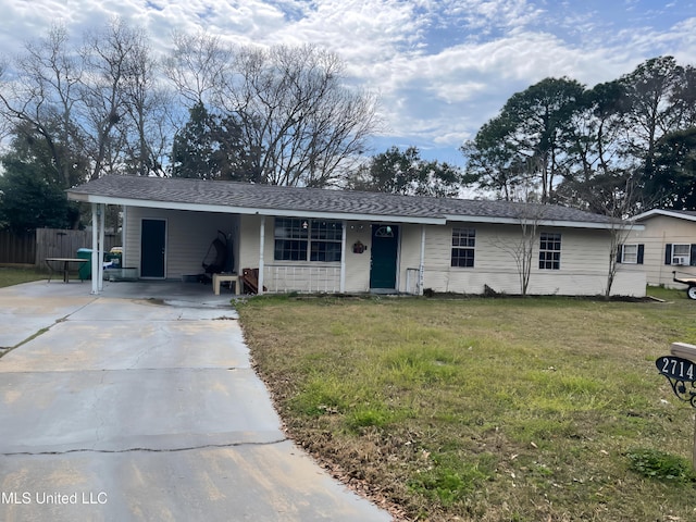 ranch-style home featuring a shingled roof, fence, driveway, a carport, and a front lawn