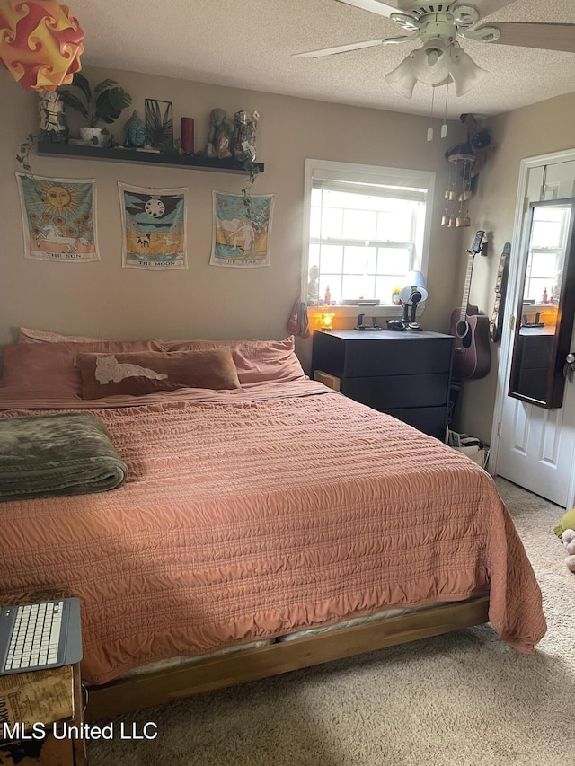 bedroom with a textured ceiling, multiple windows, and light carpet