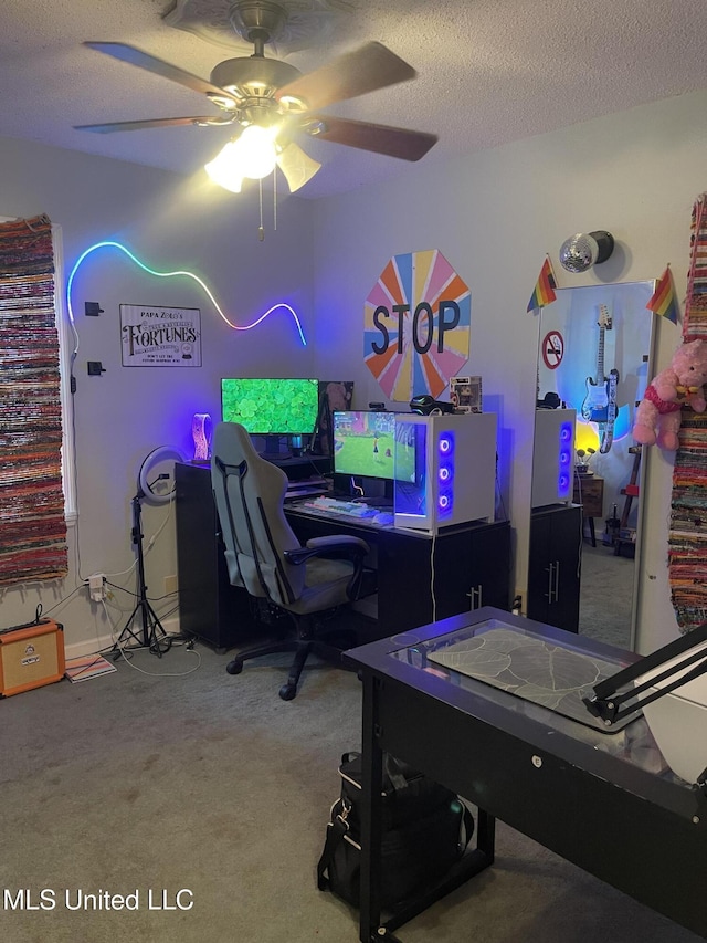 rec room with a textured ceiling, ceiling fan, and carpet flooring