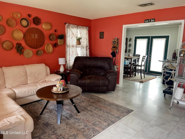 living area with french doors and visible vents