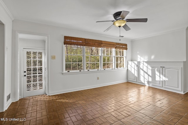 unfurnished room featuring ceiling fan and ornamental molding