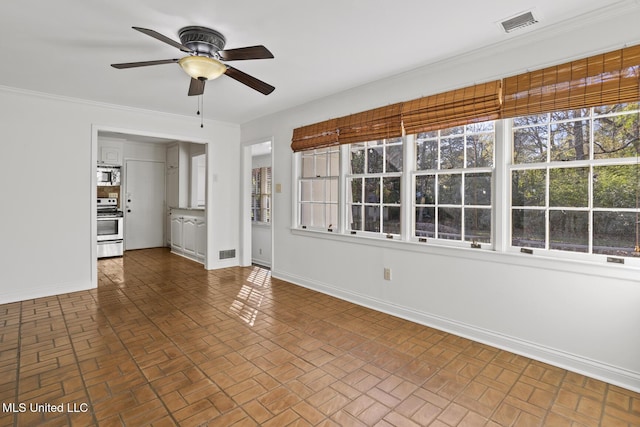 unfurnished living room with ceiling fan and ornamental molding