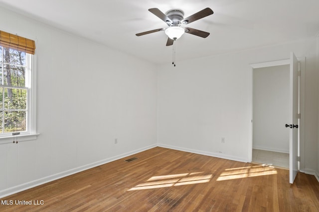 unfurnished room featuring hardwood / wood-style floors, plenty of natural light, and ceiling fan